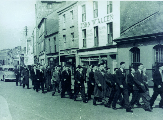 Seán South (circled) marching in the 1956 Easter Rising commemoration in Limerick. At the bottom left-hand corner is the badge worn by all IRA volunteers during the 1956â€“62 border campaign. (Des Long)