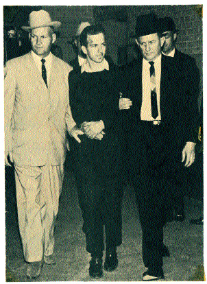 Oswald being escorted from a Dallas police station, seconds before he was gunned down by Jack Ruby. Some conspiracy theorists claim that they knew each other.