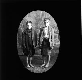 Two Dublin street urchins, autumn 1913. Although often recalled with nostalgia, the photographic record is striking for the sheer multitude of children and families living in overcrowded, dirty, squalid conditions. (Royal Society of Antiquaries of Ireland)