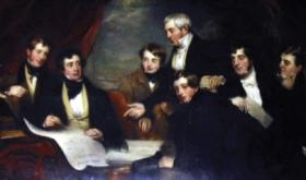 Family portrait of the Barrington family in 1830 (by Martin Cregan), preparing plans for the Limerick hospital that bore their name. The plaque over the door credits Joseph with its establishment, but his son Matthew was the driving force behind the project. Note how Joseph (standing) points to Matthew (second from the left), recognising his elder son’s major role in the venture and acknowledging him as future head of the family. (Glenstal Abbey)