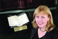 Prof. Jane Olhmeyer in Trinity’s Old Library, with a volume of Depositions in the background. (Trinity College, Dublin)