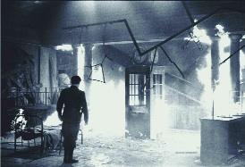 Patrick Pearse (Eoin Ó Suilleabháin) watches (top) as the interior of the GPO burns. Actors and crew had to work surrounded by smoke, explosions and a real fire. 