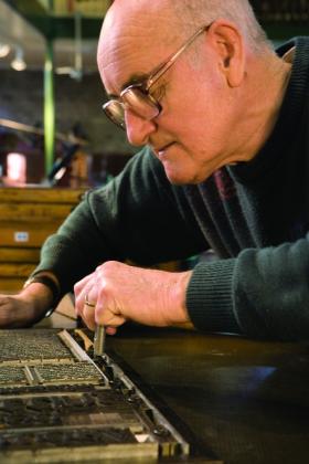 A typesetter at work — an ancient skill practised for hundreds of years ever since Gutenberg invented the printing press.