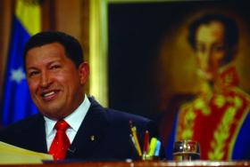 Hugo Chávez (with a portrait of his hero, Simón Bolívar, in the background), after winning his second term as president of Venezuela by a 2:1 margin in November 2006. (Indymedia)