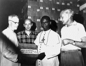 The film records feeding operations and medical care supplied in refugee camps, mainly in the vicinity of Owerri, organised under the authority of Bishop Joseph Whelan (left, accepting Caritas aid), who had presided over the Owerri diocese for the previous twenty years. (Independent Newspapers)