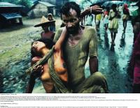 Refugee camp in Calcutta in 1971. A Bangladeshi man carries his cholera-stricken wife—just two of the estimated nine million people who fled the war across the border into India. (Mark Edwards/Still Pictures)