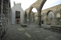 The unroofed Portlester Chapel contains original architectural features and houses tombstones taken from a nearby graveyard when it was taken over for other purposes.