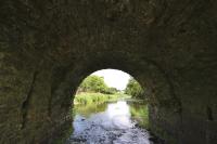 The underside of one of the arches displays a break in the barrel in which the junction of the original structure and the later extension is clear. (NIAH)