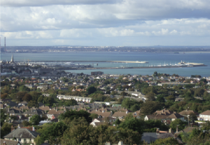 the area in 1804. The small village of Dunleary is beside a small creek and not far from Monkstown church (top left, circled). The central axis of present-day Dún Laoghaire, now George’s Street, runs diagonally from north-west to south-east and has just one building. ‘No.12’ and ‘No.13’(circled), identify proposed gun batteries. Small red circles nearby are sites for Martello towers (since demolished). (British Library)