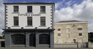 The museum is located in premises vacated by McCann’s Bakery in 1996 (original façade on the left), underneath which was revealed Nicholas Bagenal’s castle (right).